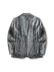 リネンブレンドのテーラードジャケット、フロントに二つボタンとパッチポケットが見える