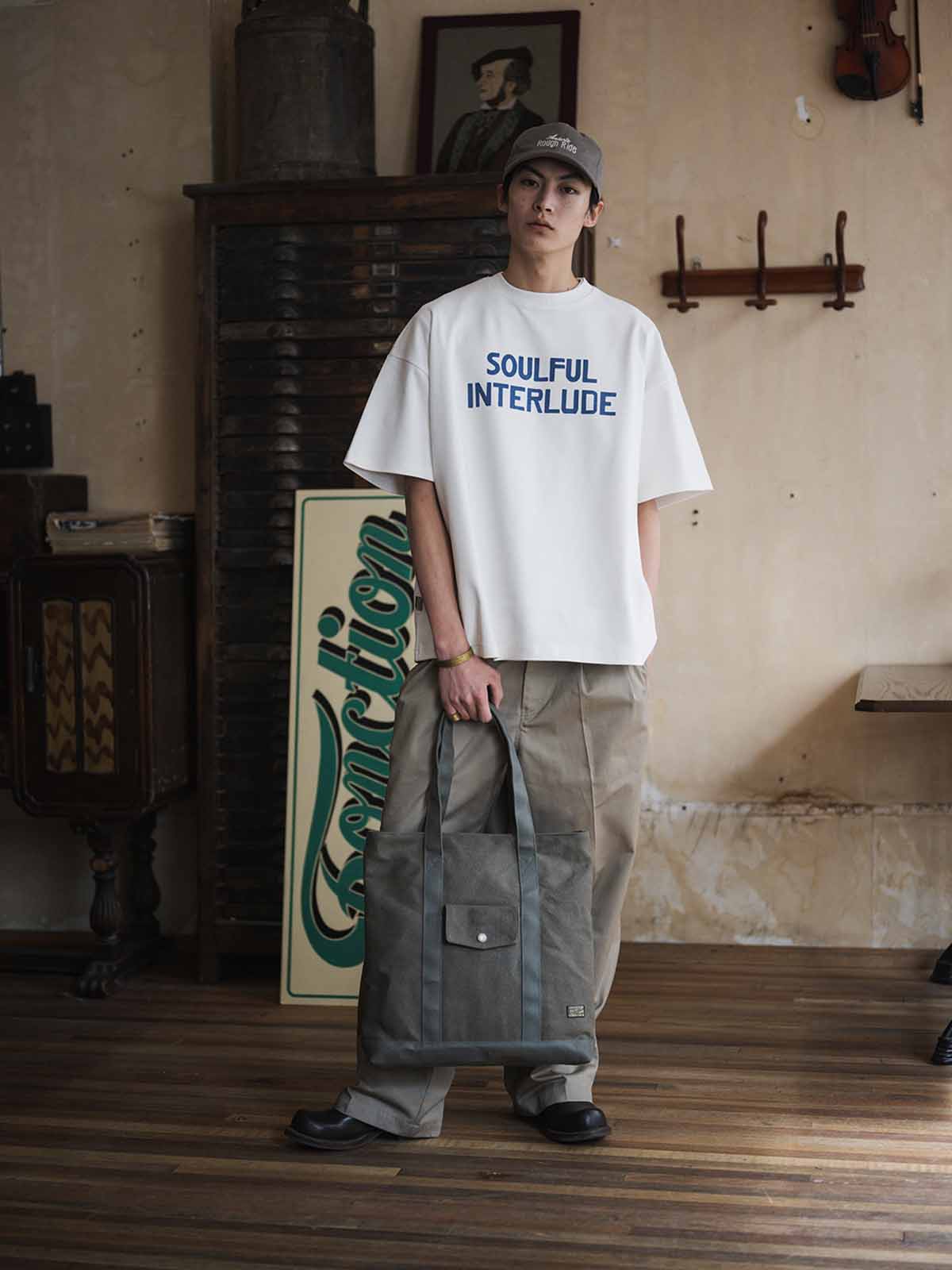 オリーブグリーン24オンスキャンバスのTalonジップ付きヴィンテージトートバッグ、前面フラップポケットと長めの肩紐の詳細。