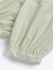 詳細画像: 清新なミルクグリーンのパフスリーブドレスの詳細図。ラウンドネックとラグランスリーブ、ギャザーのデザインを展示。