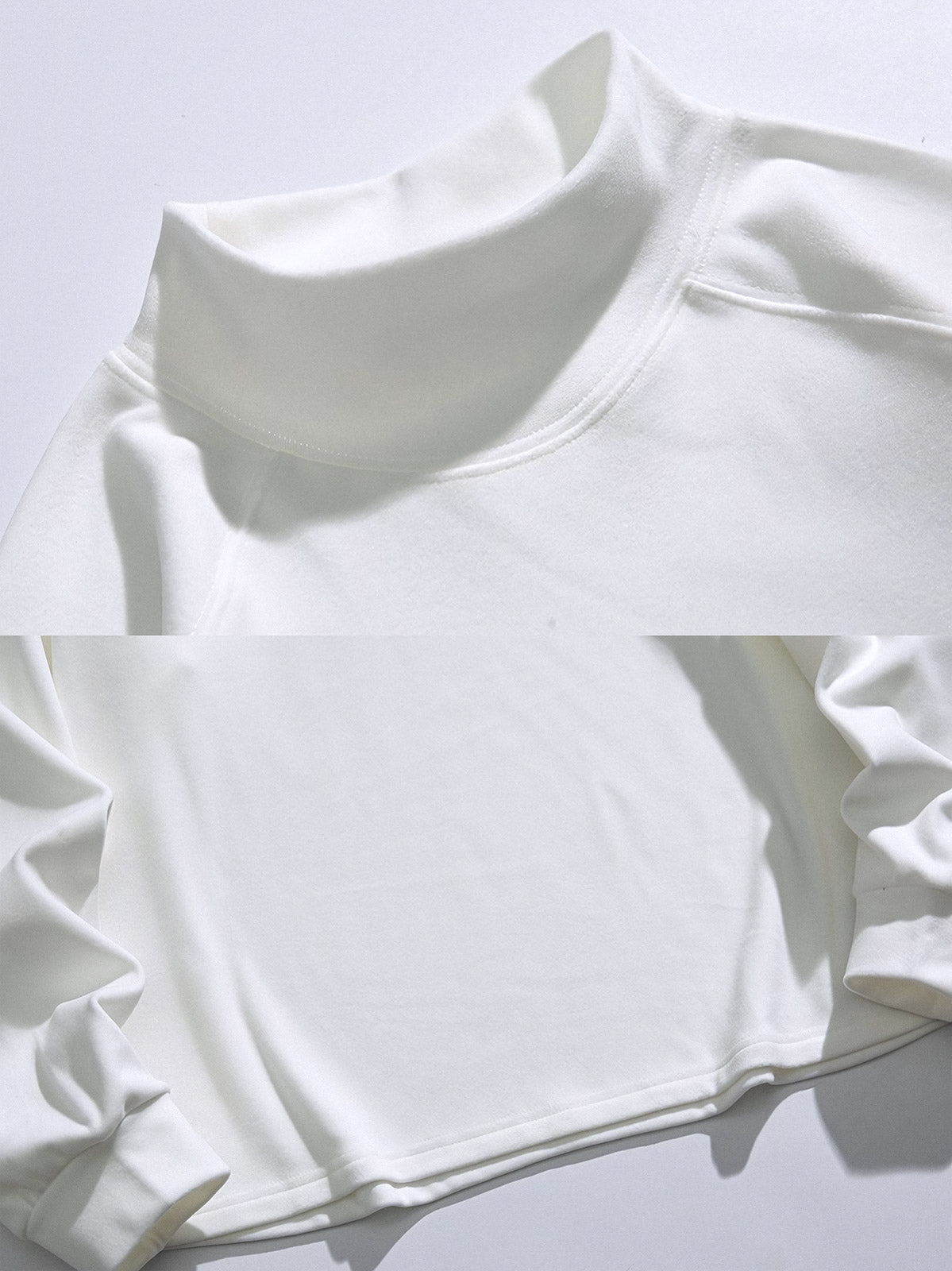 製品画像: 軽量ハイネック スウェットシャツの正面全体展示画像。ブラック、ホワイト、グレーの3色展開で、シンプルで上品なデザインが特徴。柔らかな生地感とハイネックデザインが冬のコーディネートに立体感を加え、日常使いにも最適な一着。
詳細画像: 軽量ハイネック スウェットシャツのハイネック部分をクローズアップした画像。保温性を高める立体的なデザインが特徴で、袖口と裾の細部仕上げも確認可能。シンプルなディテールでありながら、優れた着心地とファッション性を提供。