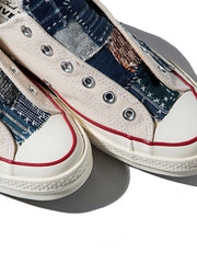 製品画像: 植物染め古布手作り刺し子パッチワーク1970Sローカットキャンバスシューズの正面画像。手工芸とヴィンテージデザインの融合が特徴的。
詳細画像: 刺し子と侗族(ドン族)の手織り布のディテール特写。伝統技術の細部が見える画像。