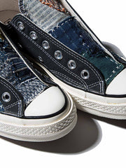 製品画像: 植物染め古布手作り刺し子パッチワーク1970Sローカットキャンバスシューズの正面画像。手工芸とヴィンテージデザインの融合が特徴的。
詳細画像: 刺し子と侗族(ドン族)の手織り布のディテール特写。伝統技術の細部が見える画像。