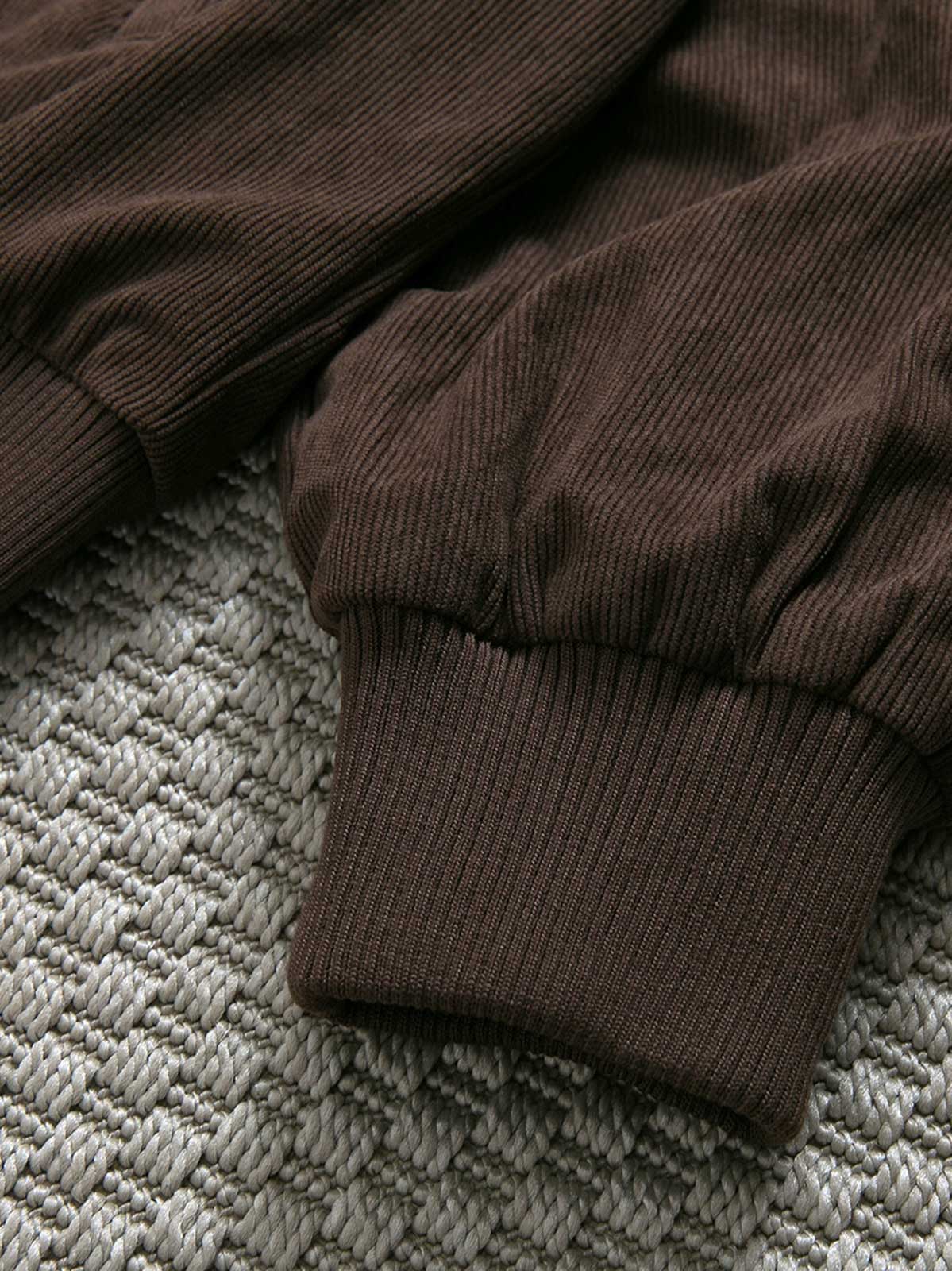 製品画像: レトロなコーデュロイジャケット平置き。シンプルな刺繍ロゴと襟付きデザインが特徴の秋冬必須アイテム
詳細画像: コーデュロイ素材の織り目と刺繍ロゴのディテール。保温性と軽量感を備えたジャケット