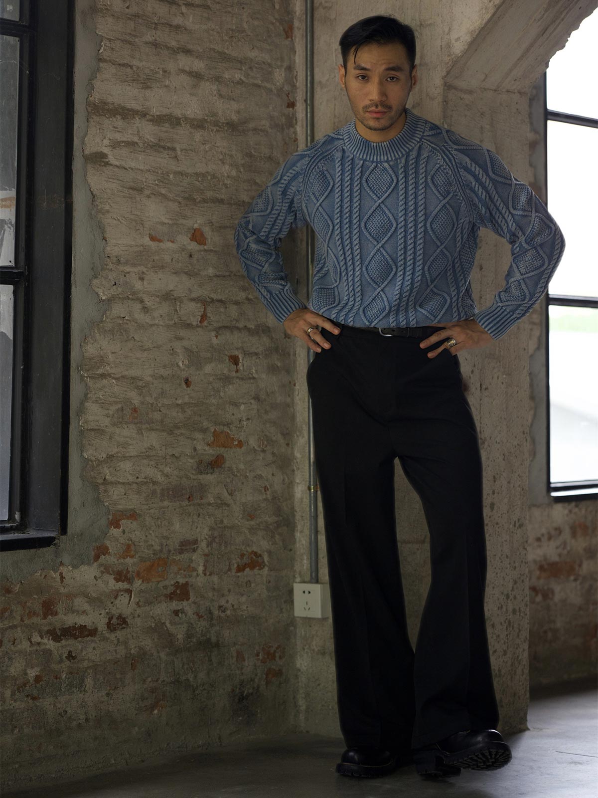 詳細画像: セーターのケーブル編みとウォッシュ加工のディテール - ヴィンテージ感を演出
モデル画像: 男性モデルが着用するアメカジ風ツイストケーブルセーラーセーター - 全体スタイルと着こなし例