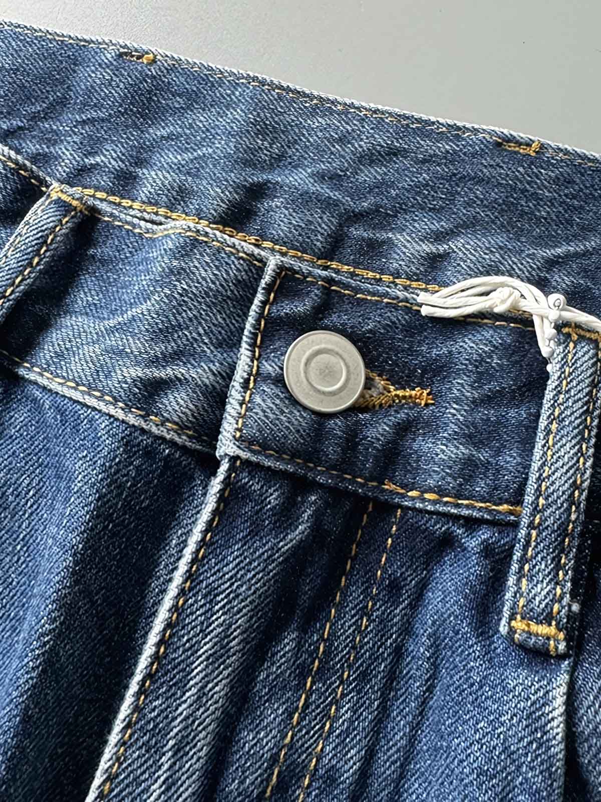 製品画像: 刺繍デザインが特徴のテーパードシルエットデニムパンツ全体画像
詳細画像: ポケット部分の刺繍ディテールとクラシックデニムブルーの生地