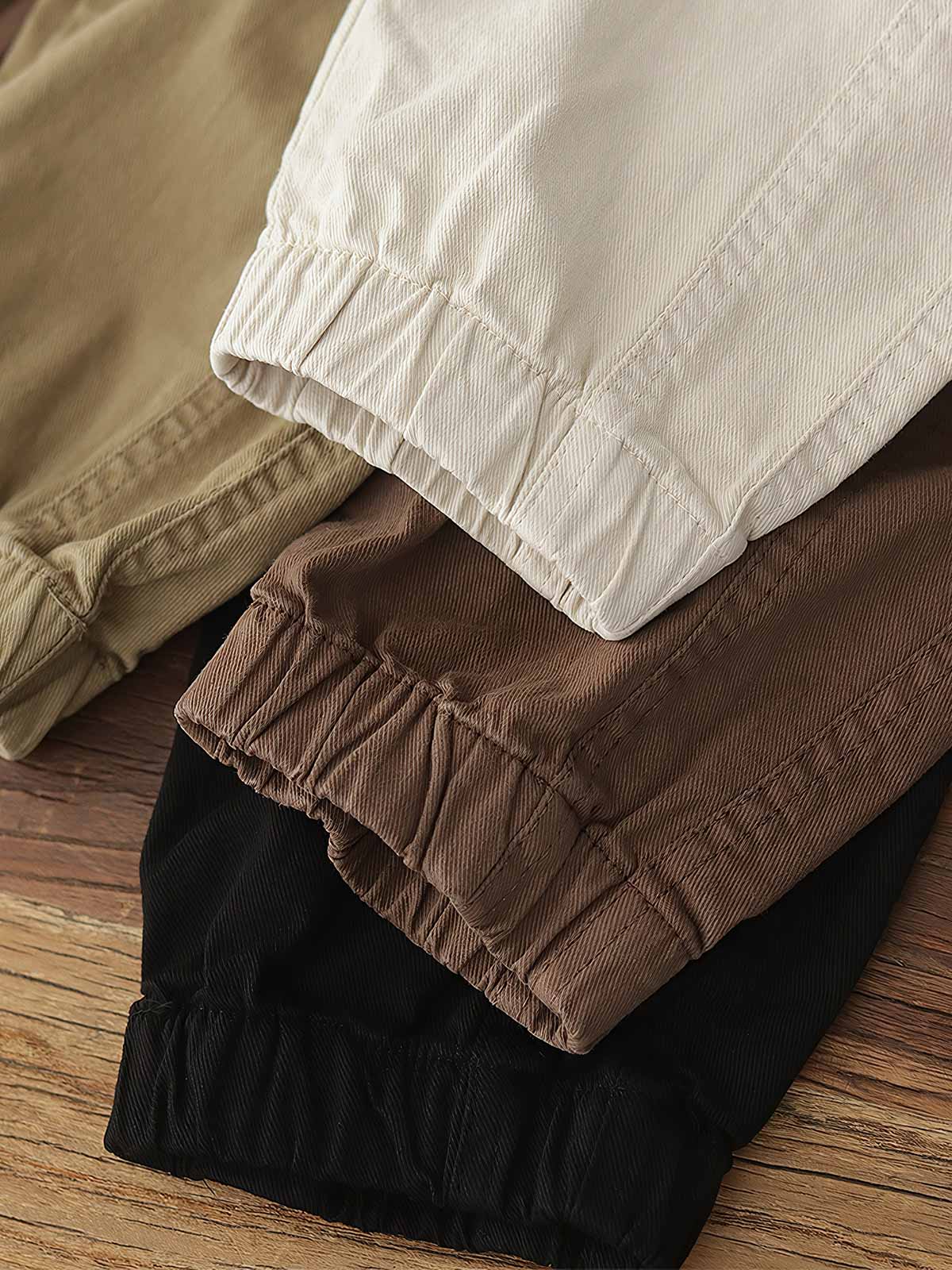 製品画像: ヴィンテージワーク パラシュートジョガーパンツ 正面、ウォッシュ加工とリブウエストデザイン
詳細画像: リブウエストと大きめポケットのディテール、微ストレッチツイル