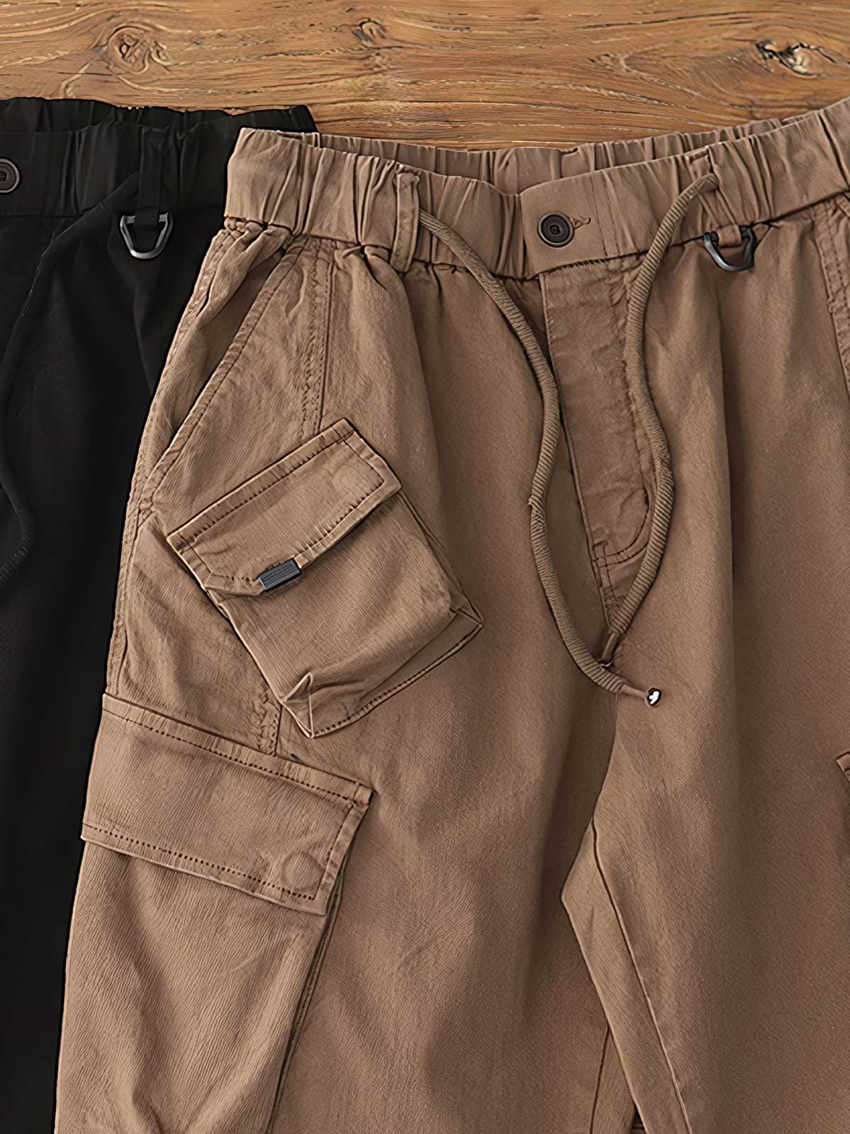 製品画像: ヴィンテージワーク パラシュートジョガーパンツ 正面、ウォッシュ加工とリブウエストデザイン
詳細画像: リブウエストと大きめポケットのディテール、微ストレッチツイル