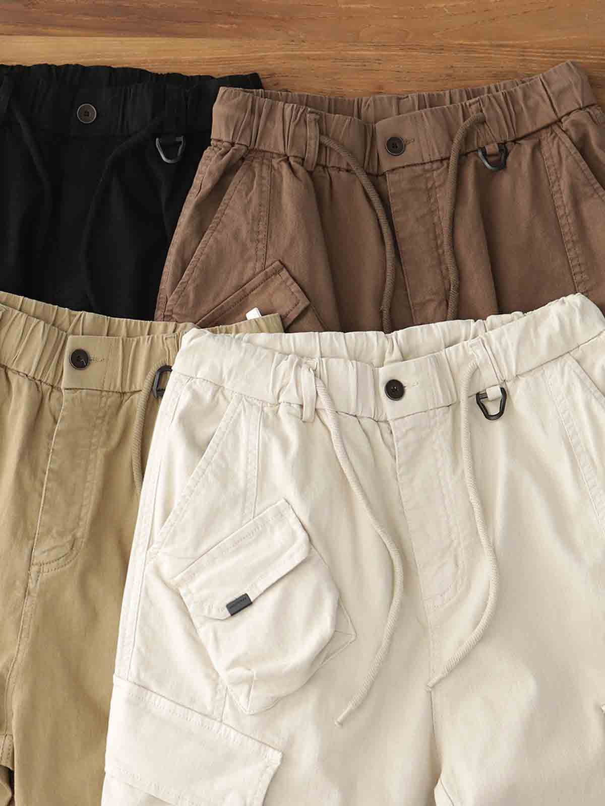 製品画像: ヴィンテージワーク パラシュートジョガーパンツ 正面、ウォッシュ加工とリブウエストデザイン
詳細画像: リブウエストと大きめポケットのディテール、微ストレッチツイル