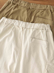 製品画像: ヴィンテージワーク パラシュートジョガーパンツ 正面、ウォッシュ加工とリブウエストデザイン
詳細画像: リブウエストと大きめポケットのディテール、微ストレッチツイル