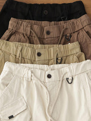 製品画像: ヴィンテージワーク パラシュートジョガーパンツ 正面、ウォッシュ加工とリブウエストデザイン
詳細画像: リブウエストと大きめポケットのディテール、微ストレッチツイル