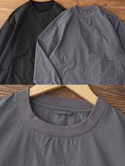 製品画像: 軽量 Cordura ナイロン 速乾トップ 正面、耐摩耗性・リップストップ機能
詳細画像: 両サイドの大容量ポケットと伸縮性のある袖口のディテール、オーバーサイズシルエット