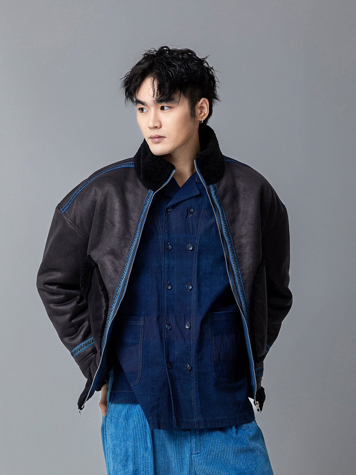 詳細画像: 草木模様のテープパッチワークディテール表示。ヴィンテージ感と高級感を兼ね備えたユニークな仕上がり。
モデル画像: モデル着用による厚手ムートンジャケットのシティスタイル。冬のカジュアルシーンに最適なアウター。