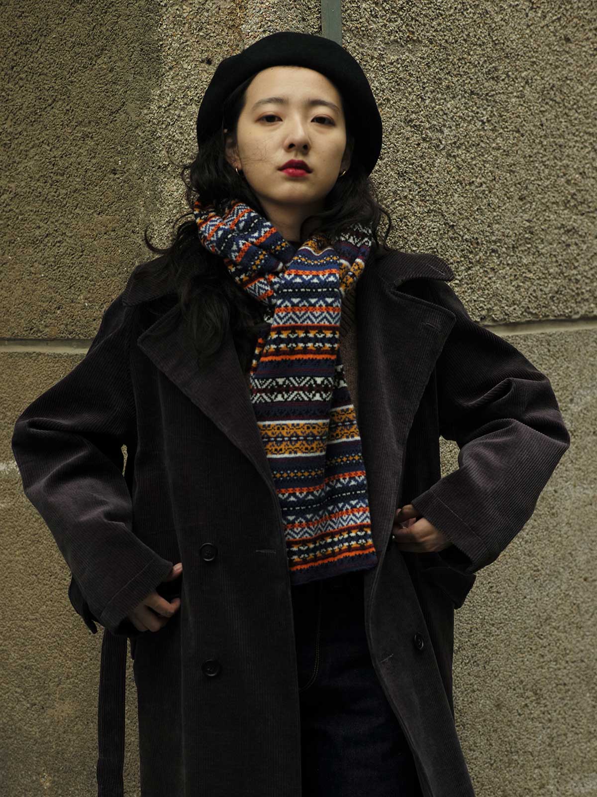 詳細画像:マフラーの織り目とフェアアイランド柄のディテールが鮮明に描かれており、シェトランドウール特有の柔らかな質感と耐久性が伝わります。染色技術にこだわったカラフルな糸が、アクセントとなる美しいデザインを際立たせています。
モデル画像:シェトランドウールのフェアアイランド柄マフラーを着用したモデルが、ヴィンテージ感のあるスタイルでコーディネートしています。マフラーの柔らかさと温かさが際立ち、日常的なカジュアルスタイルにもぴったりのアイテムであることを示しています。