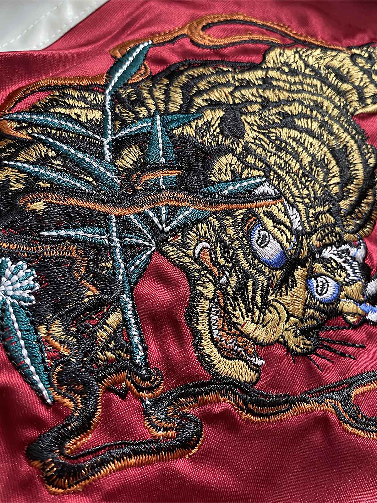 製品画像: リバーシブル 刺繍 横須賀 水滸伝 鬼若丸 ベルベット ジャケットの全体画像、日本の伝統とヴィンテージデザイン
詳細画像: 水滸伝 武松の虎退治と鬼若丸の鯉退治の刺繍ディテール、横須賀刺繍の精緻な技法