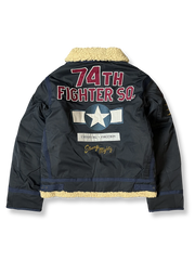 製品画像: 第74戦闘飛行中隊 B3 フライトジャケットの全体画像、シープスキン裏地とクラシックなミリタリースタイル
詳細画像: 背面の「74th FIGHTER SQ.」ロゴとアメリカ空軍マークの刺繍ディテール