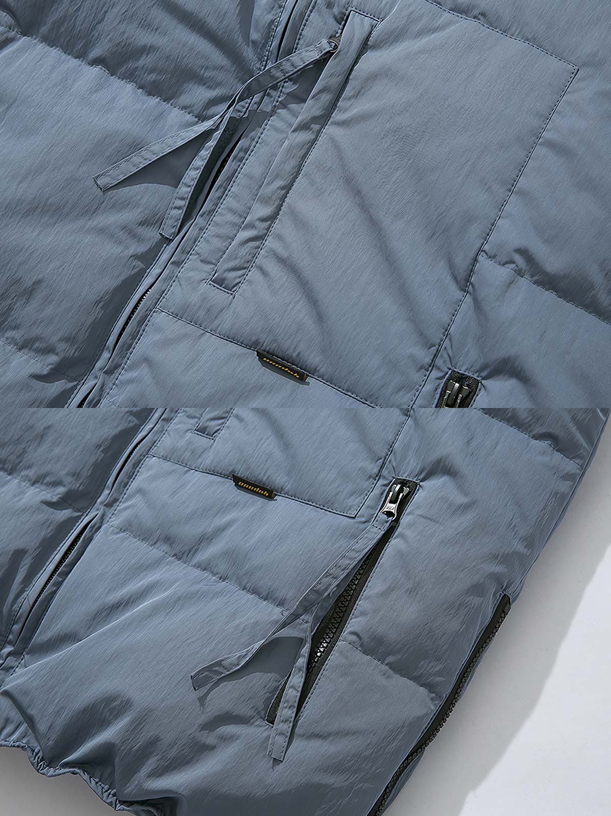 製品画像: 多ポケットデザインのワークダウンベスト、スタンドカラーと70%-79%ホワイトダックダウン充填による高保温性が特徴の全体イメージ
詳細画像: ワークスタイルのダウンベストに施されたジッパー付きサイドスリットとポケットディテールのクローズアップ