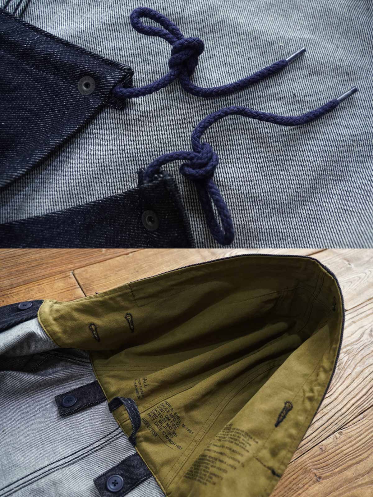 製品画像: デニムバージョンのM51フィッシュテールコート全体イメージ画像。特注のデニム素材で再現されたヴィンテージミリタリースタイルが特徴的。シルバーカラージッパーやブルー樹脂ボタンなど、細部までこだわったデザインが魅力。
詳細画像: YKK製スナップボタンと特注シルバーカラージッパー、ブルー樹脂ボタンのディテールをクローズアップした画像。ヴィンテージ感を引き立てる丁寧なディテールが際立つ。