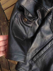 製品画像: 9ポケットフィールドフード付きフルグレインレザージャケット全体イメージ画像。黒いシボ加工レザーとヴィンテージ感漂うオイル仕上げのスエードディテールが特徴で、アウトドアやバイクライドにも適した多機能デザイン。
詳細画像: YKKアンティークブロンズジッパーとオイルドスエードレザーの補強ディテールをクローズアップした画像。耐久性とクラシックな風合いが際立つ仕上がり。