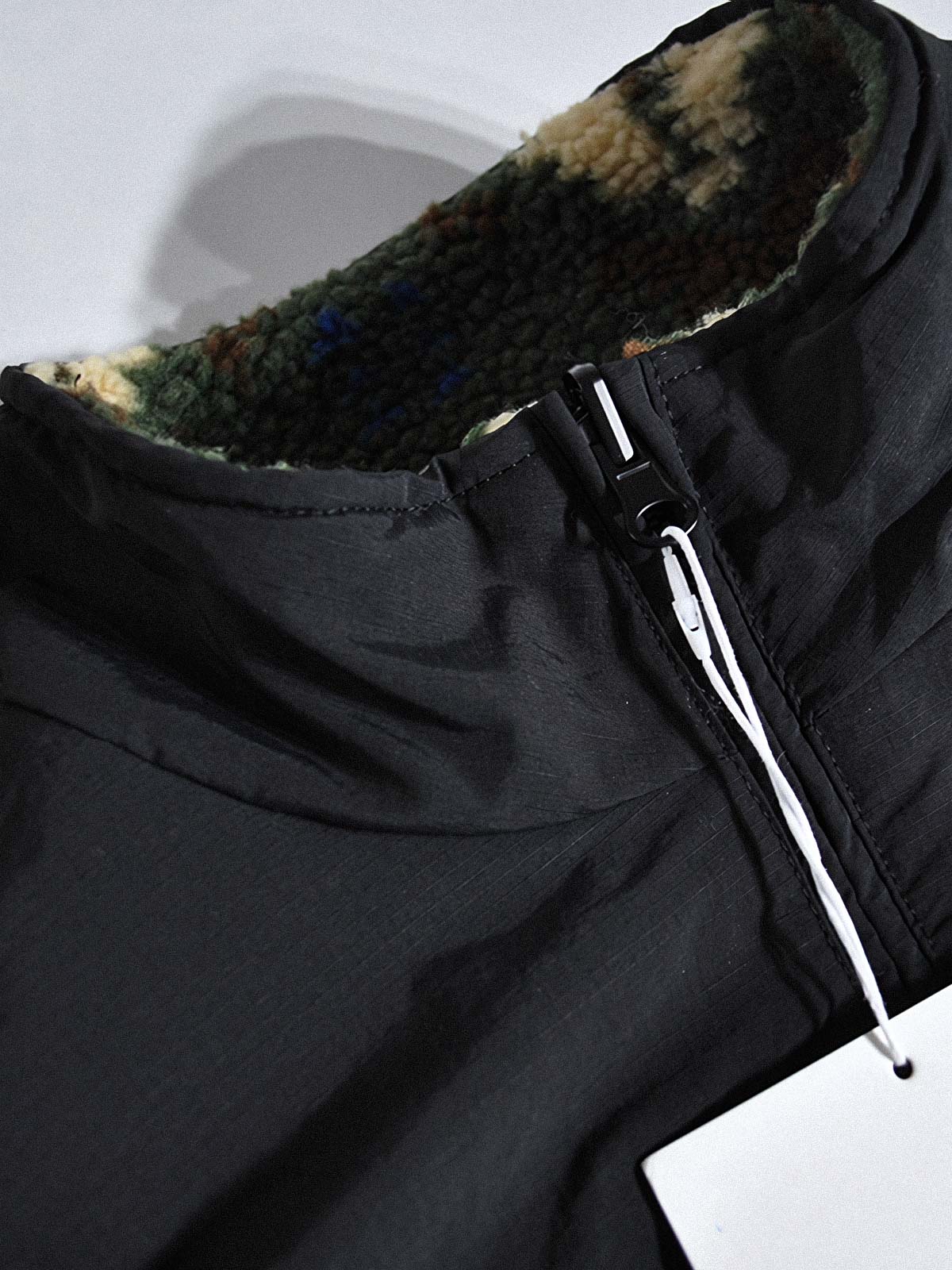 製品画像:
リバーシブルフェイクシアリング中綿ジャケット、アウトドア素材と民族風フェイクシアリングデザインを融合、秋冬の実用的で暖かいアイテム
詳細画像:
民族風フェイクシアリング素材と高密度アウトドア素材のディテールクローズアップ、防風性とデザイン性を兼ね備えたリバーシブルジャケット