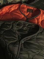 製品画像: 弧形キルティングデザインの軽量インナーダウンジャケット、ミリタリースタイルでレトロ感と現代的な機能性を兼ね備えた秋冬の必須アイテム。
詳細画像: リバーシブルデザイン(オリーブグリーンとレスキューオレンジ)、袖口のリブ編みが冷気をシャットアウト。軽量でありながら優れた保温性を提供。