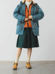 詳細画像: ツートーンのダイヤ柄キルティング加工が施されたコート、ポリエステル素材で軽量かつ耐久性のあるデザイン、ディテールにこだわったアクセント。
モデル画像: スカートやパンツとのコーディネートでイギリス風スクールスタイルを演出したモデルが着用したピーターパンカラーコート。