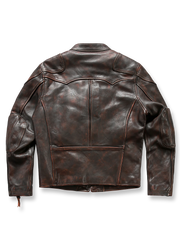 製品画像: タフレザージャケットの全体展示画像。クラシックなアメリカンモーターサイクルスタイルを再現したデザインで、茶芯レザーの独特なヴィンテージ感と重厚感が際立つ。
詳細画像: 茶芯レザーの質感とヴィンテージ加工をクローズアップしたディテール画像。1.8mm厚のフルグレインカウハイドを使用し、自然な光沢と独特のシワが魅力。タロンジッパーの精巧な作りも確認できる。