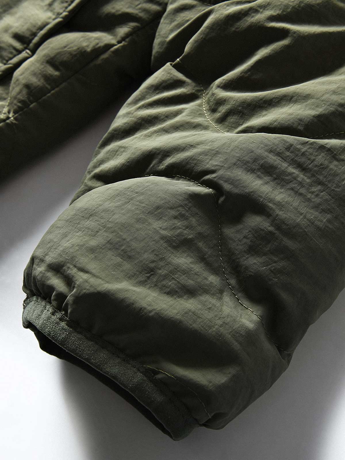 製品画像
「4色展開の防風防水中綿ジャケット。アウトドア素材とポリエステル中綿を採用し、軽量設計で保温性と高機能性を兼ね備えた全体写真。」
詳細画像
「防風性に優れたアウトドア素材の質感と軽量化された中空構造ポリエステル繊維を使用した中綿ディテール。多機能ポケットの実用性も際立つ中綿ジャケット詳細写真。」