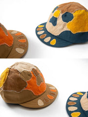 製品画像: 柿渋染め ハンドメイド パッチワーク 刺し子 スカル キャップ。伝統的な染色技術とスカルモチーフのパッチワークデザインが特徴的なキャップの正面全体展示図。
詳細画像: 丁寧な刺し子技術とスカルデザインのパッチワークディテール、自然な粒子感を引き立てる水洗い染色加工のクローズアップ。