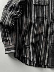 製品画像
「ヘビーフランネル素材を使用したストライプ長袖シャツ全体展示図。ウォッシュ加工によりヴィンテージ感が漂い、クラシックなアメリカンカジュアルスタイルを再現。」
詳細画像
「フランネル素材のテクスチャーと金属ボタンのディテール特写。ウォッシュ加工による自然な風合いと、実用的でデザイン性のある金属ボタンが魅力。」