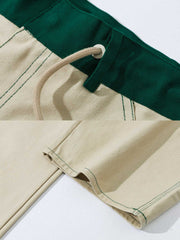 製品画像: 厚手キャンバスワークパンツの正面展示図。高密度キャンバス生地を使用した丈夫な素材感とシンプルでシャープなストレートシルエット。
詳細画像: ワークパンツのカラーブロックデザイン、ウエスト部分のドローコードによる調節機能とサイドポケットのディテール。