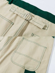 製品画像: 厚手キャンバスワークパンツの正面展示図。高密度キャンバス生地を使用した丈夫な素材感とシンプルでシャープなストレートシルエット。
詳細画像: ワークパンツのカラーブロックデザイン、ウエスト部分のドローコードによる調節機能とサイドポケットのディテール。