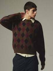 詳細画像: ダイヤ柄の滑らかな編み地のディテールクローズアップ画像。軽量で柔らかい混紡素材が持つ快適さと暖かさを示す。
モデル画像: ダイヤ柄クルーネックニットを着用したモデルによるカジュアルコーディネートイメージ。デニムやワークパンツとの組み合わせでレトロなスタイルを楽しめる。