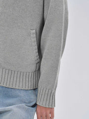 詳細画像: ケーブル編みディテールとマットシルバージッパーの特写。細部の編み模様とジッパーが際立つ画像。
モデル画像: ケーブル編みカーディガンとデニムを組み合わせた秋冬カジュアルスタイル。モデルがリラックスした日常スタイルを披露。