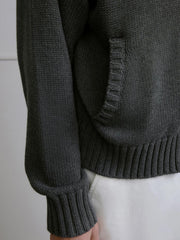 詳細画像: ケーブル編みディテールとマットシルバージッパーの特写。細部の編み模様とジッパーが際立つ画像。
モデル画像: ケーブル編みカーディガンとデニムを組み合わせた秋冬カジュアルスタイル。モデルがリラックスした日常スタイルを披露。