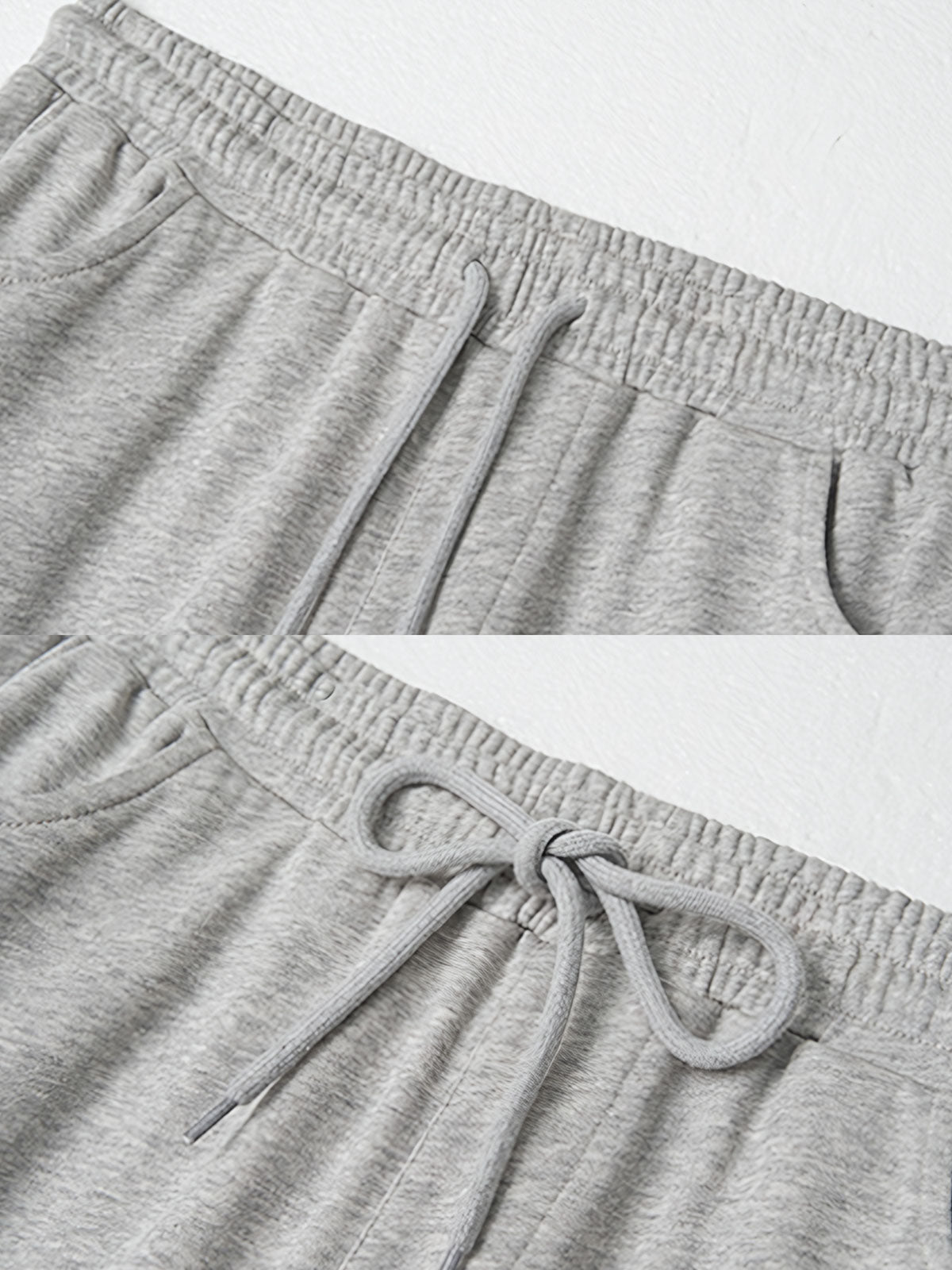 製品画像: レトロなコットン混紡ニットスウェットパンツの全体展示。シンプルなストレートシルエットとロールアップ裾が特徴のカジュアルスウェットパンツ。
詳細画像: ウエスト部分のゴムとドローストリング、裾のロールアップディテール特写。ウエストと裾のデザインが引き立つ特写。