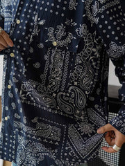 製品画像
ペイズリー柄シアサッカーシャツの正面デザイン。アメリカンバンダナ文化を反映した不規則なプリントパターンと、軽量で通気性の高いシアサッカー生地が特徴
詳細画像
3つのポケットと独特なシワ感を持つシアサッカー生地のディテール。18針/3cmの高密度縫製工法による精密な仕上がりが際立つ