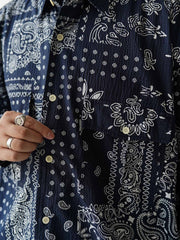 製品画像
ペイズリー柄シアサッカーシャツの正面デザイン。アメリカンバンダナ文化を反映した不規則なプリントパターンと、軽量で通気性の高いシアサッカー生地が特徴
詳細画像
3つのポケットと独特なシワ感を持つシアサッカー生地のディテール。18針/3cmの高密度縫製工法による精密な仕上がりが際立つ