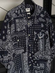 製品画像
ペイズリー柄シアサッカーシャツの正面デザイン。アメリカンバンダナ文化を反映した不規則なプリントパターンと、軽量で通気性の高いシアサッカー生地が特徴
詳細画像
3つのポケットと独特なシワ感を持つシアサッカー生地のディテール。18針/3cmの高密度縫製工法による精密な仕上がりが際立つ