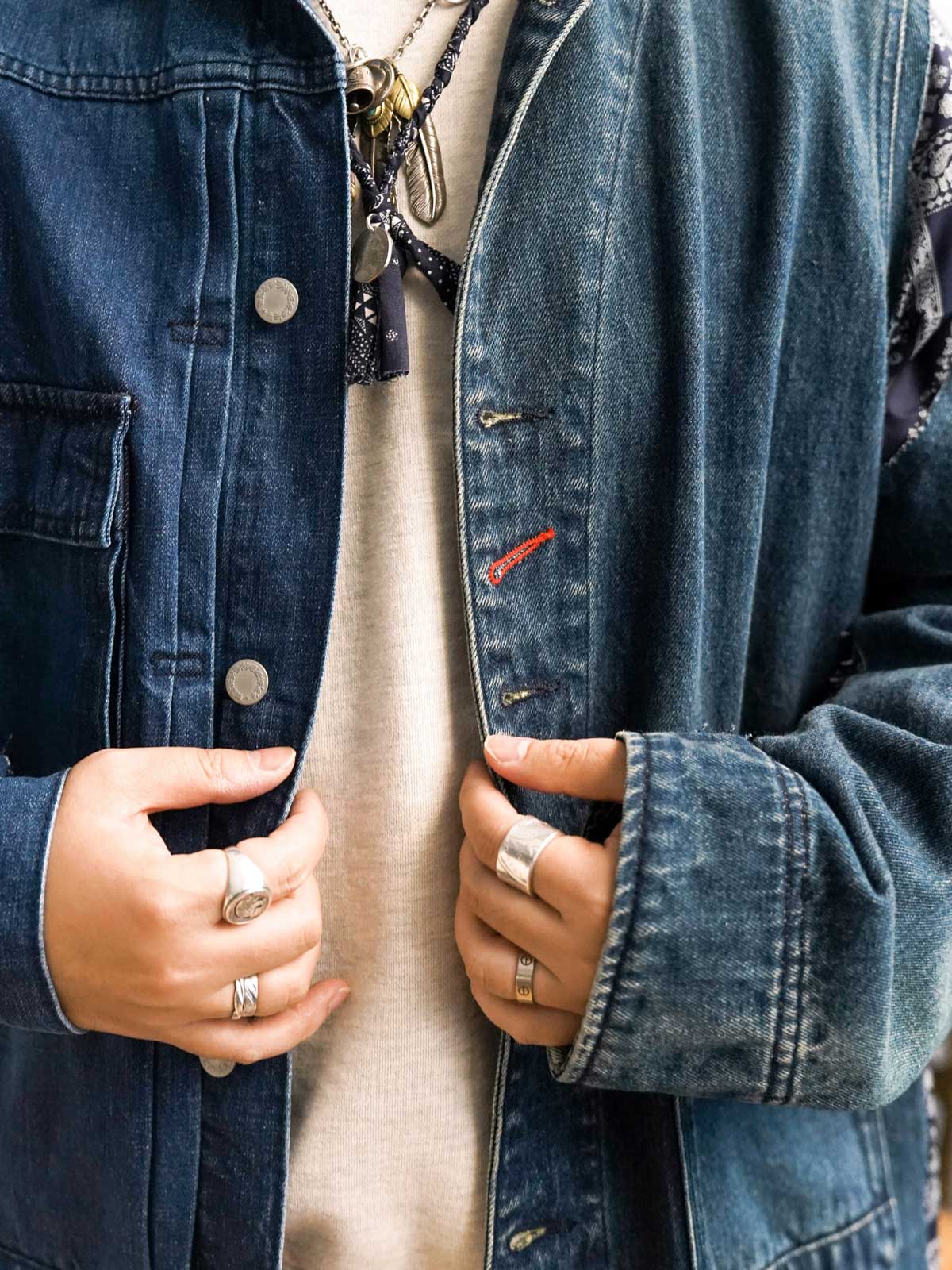 製品画像
「デコンストラクション パッチワーク ペイズリー柄 デニムジャケットの正面全体図。左右非対称デザインが特徴で、袖口やサイドシーム、裾部分にペイズリー柄のパッチワークを施した、ヴィンテージ感あふれる独特な解体美学のデザイン。オーバーサイズシルエットで快適な着心地を提供する希少な一着。」
詳細画像
「デコンストラクション パッチワーク ペイズリー柄 デニムジャケットのディテール特写。袖口や裾に施されたペイズリー柄パッチワークのクラフトマンシップや、意図的にずらしたボタンデザインが、ヴィンテージ感と個性を際立たせる。左右非対称の再構築デザインが視覚的なユニークさを演出。」