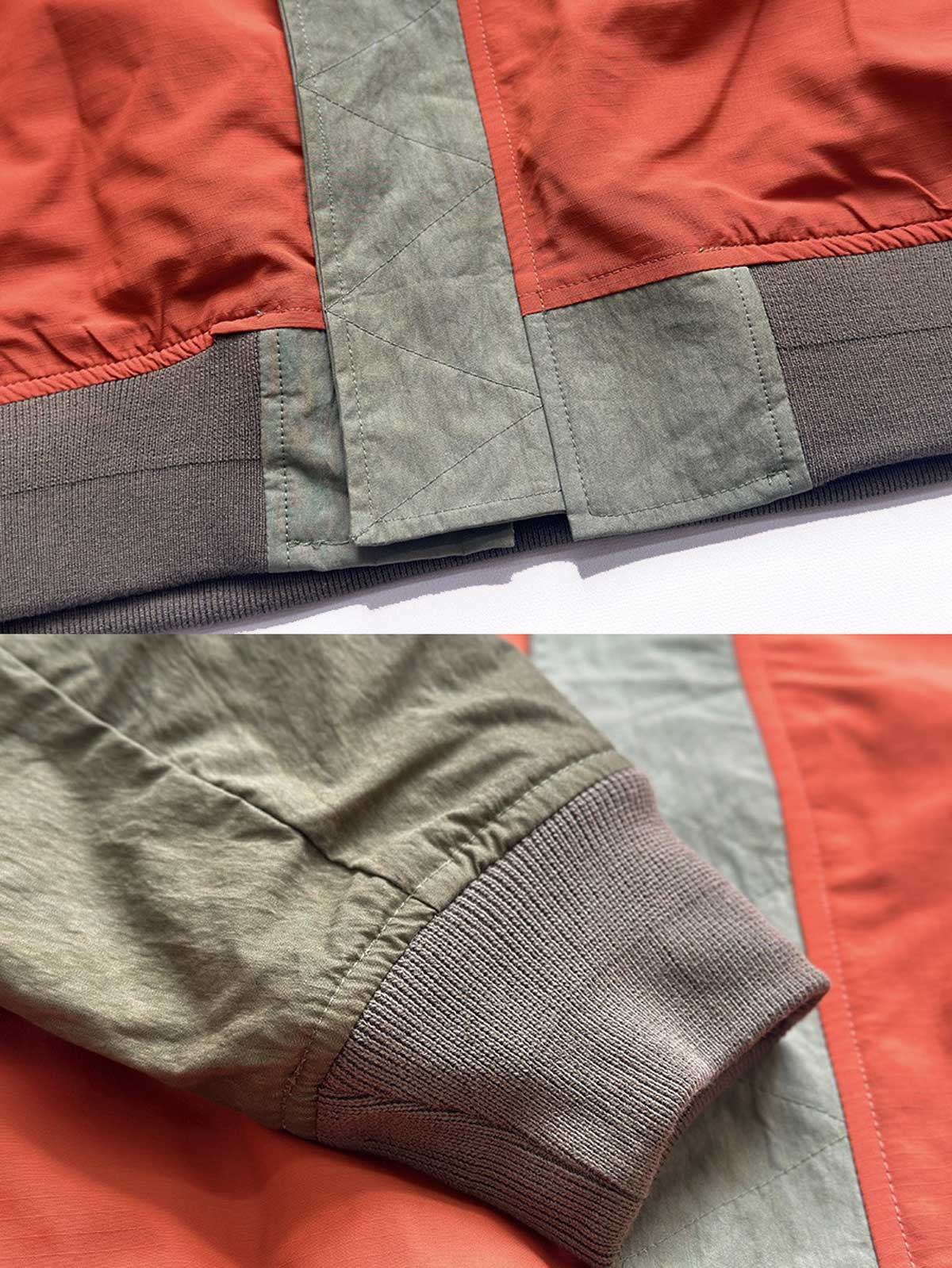 製品画像: リバーシブルジャケット(アーミーグリーン面)の全体展示図。表面にはアーミーグリーンのシンプルで落ち着いたデザイン、裏面には鮮やかなオレンジ色のアクセントが施されており、両面で異なるスタイルが楽しめる。
詳細画像: リバーシブルジャケットの表裏切り替えデザインとジッパー装飾ディテールの特写。防風防水機能素材で春秋の天候に対応し、実用性とスタイルを両立。