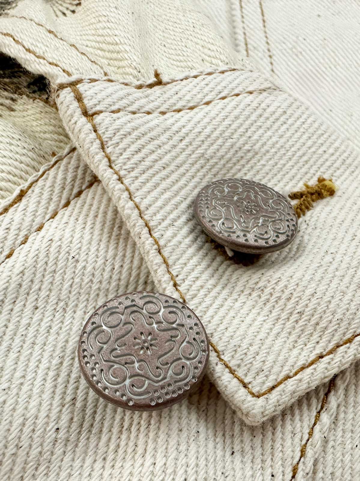 製品画像: 水墨画松柏プリントヴィンテージジャケット全体展示図。東洋美術の水墨画風デザインがジャケット全体に施され、松と柏の自然の美を強調した一着。
詳細画像: ジャケットの金属ボタンと松柏プリントディテールを特写した画像。A+級色堅牢度で、プリントの鮮やかさと耐久性を長期間保つ。