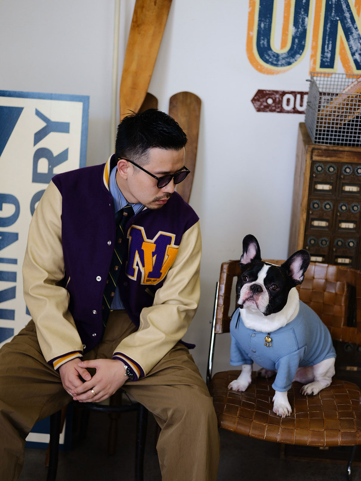 詳細画像: 刺繍レタリングとレザー切り替え袖のディテール、ヴィンテージ感のある精緻な作り
モデル画像: アイビー風ヴィンテージベースボールジャケットの着用イメージ、キャンパススタイルとストリートファッションの融合