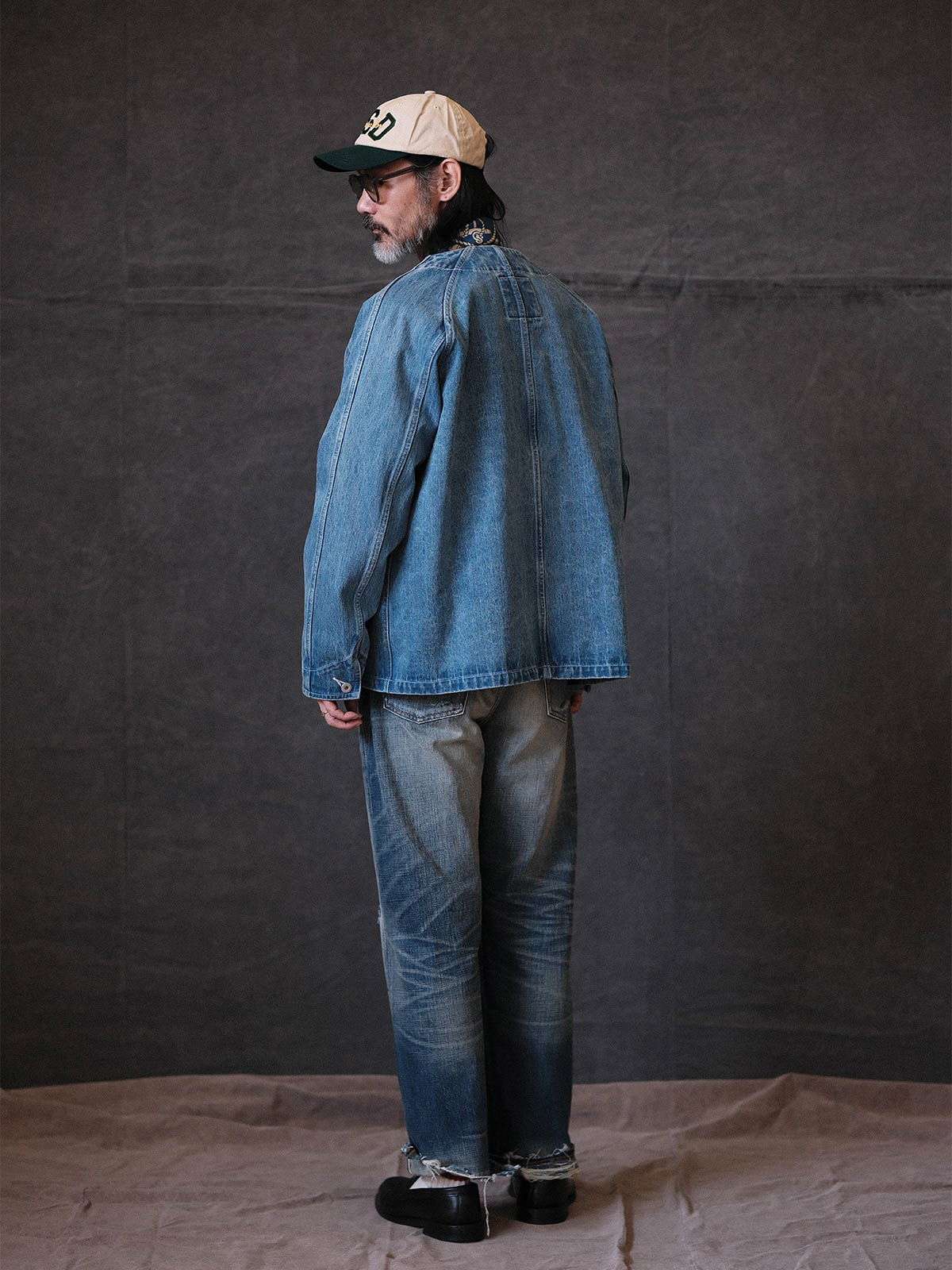 詳細画像: チャイニーズボタンやウォッシュ加工のディテールが見えるジャケットの画像
モデル画像: ヴィンテージウォッシュデニムチャイニーズボタンワークジャケットを着用したモデルの全身画像