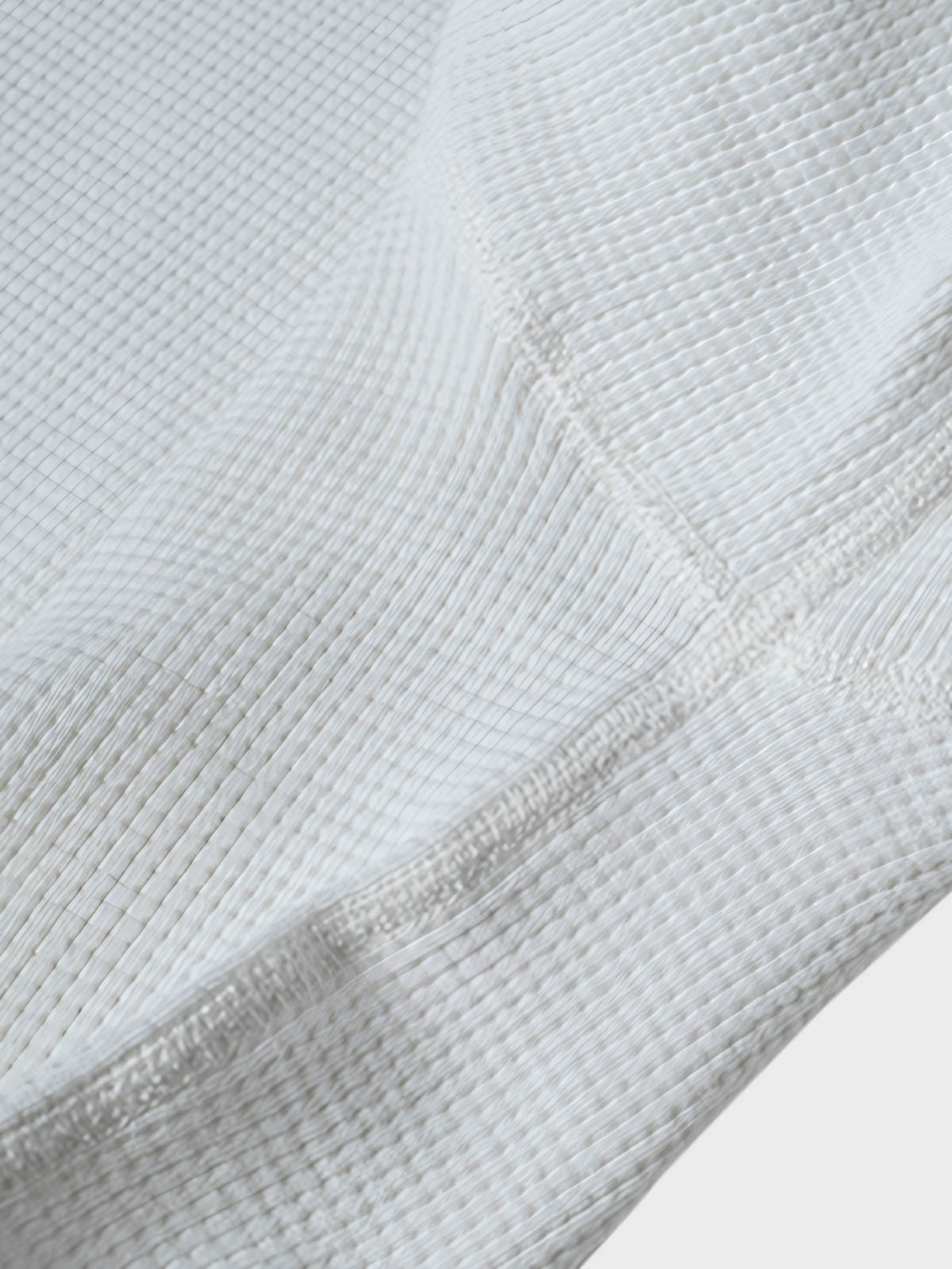 長袖Tシャツのワッフル格子テクスチャーのクローズアップ、外観の質感と衣服の吸湿性と保温性を強調。