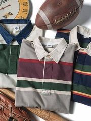 製品画像
グレーとバーガンディを基調としたブロックストライプデザインのラグビーシャツ。太いストライプと細いラインの組み合わせが80-90年代のアメカジカレッジスタイルを忠実に再現したクラシックな一着
詳細画像
ピュアコットン素材の襟元とグレーとバーガンディのブロックストライプ切り替え部分のディテール。丁寧な裁縫技術が際立つ仕上がりで、セロスパン技術によるヘビーウェイト生地の質感が魅力