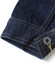 製品画像
1940年代戦時中のS101Jを忠実に再現したリバイバルデニムジャケットの正面デザイン。14オンスのセルビッジデニムとヴィンテージ感溢れるインディゴブルーの色合いが特徴
詳細画像
鉄製の月桂(ゲッケイ)ボタンと真鍮製フライングソーサーリベットのディテール。経年変化による自然な錆びが美しく、クラシックなワークウェアの魅力を引き立てる精密な縫製