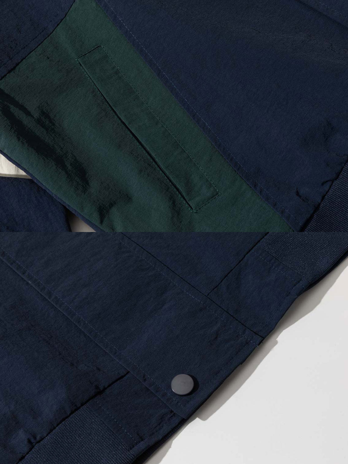 製品画像
「スタイリッシュなバイカラーパッチデザインが特徴のスポーツジャケット全体展示図。現代的なスポーツスタイルとヴィンテージ要素が融合し、独特で個性的な雰囲気を演出。」
詳細画像
「胸元の精巧な刺繍ロゴと袖口リブのディテール特写。リブが防風性と保温性を高め、全体のデザインが質感を引き立てています。」