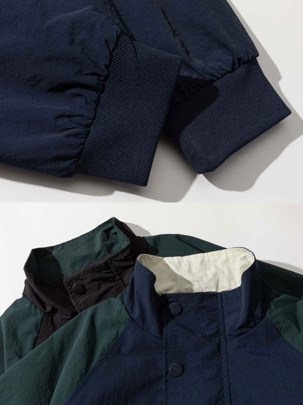 製品画像
「スタイリッシュなバイカラーパッチデザインが特徴のスポーツジャケット全体展示図。現代的なスポーツスタイルとヴィンテージ要素が融合し、独特で個性的な雰囲気を演出。」
詳細画像
「胸元の精巧な刺繍ロゴと袖口リブのディテール特写。リブが防風性と保温性を高め、全体のデザインが質感を引き立てています。」