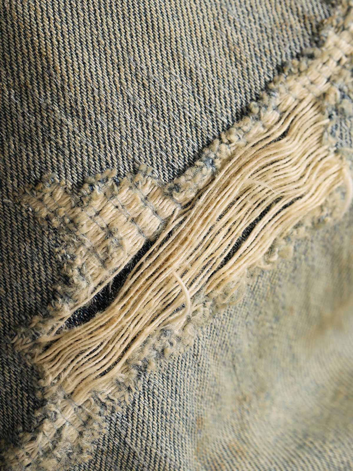 フレアパンツの三角形切り替えデザインとダメージ加工のディテール