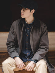 詳細画像: クラシックなコーデュロイ襟と経年変化するオイルワックス生地のディテール。独特なシワとヴィンテージ感を演出
モデル画像: モデルが着用した防水オイルワックスコートの全身スタイリング。日常通勤からアウトドアまで対応するアメカジレトロスタイル